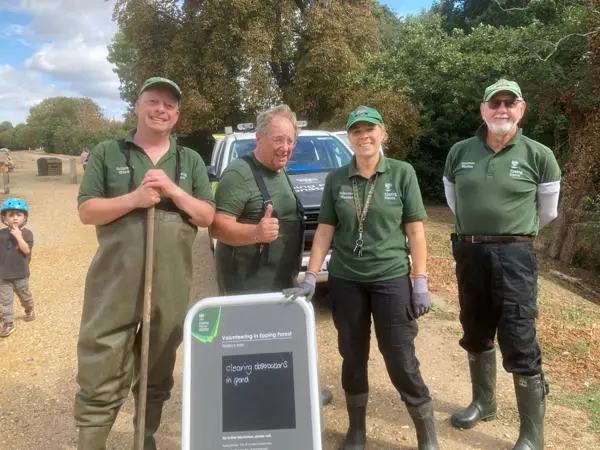 Volunteers with waders and net ready for pond clearing.