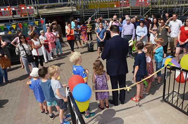 People watch ribbon cutting