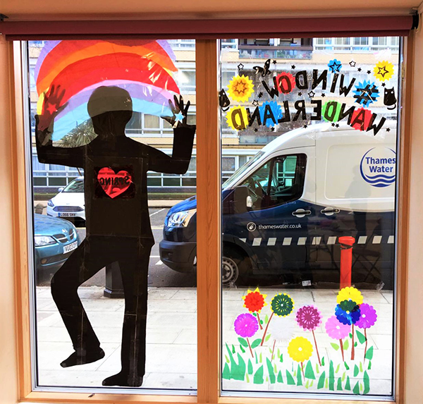 Window display of a woman's silhouette and flowers