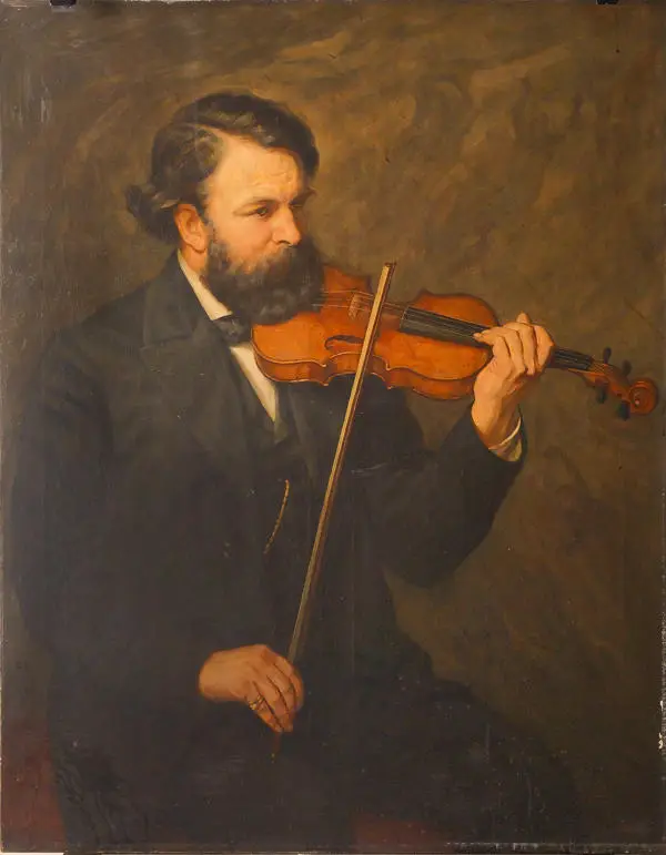man with a beard in a dark suit playing the violin