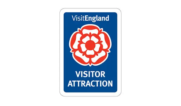 Red rose over blue background with Visit England and Visitor Attraction wording
