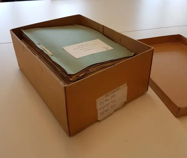 An opened archive storage box, containing Begley files
