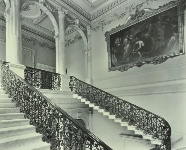 View of a grand staircase, with painting on the wall, in Chesterfield House, Curzon Street, 1932