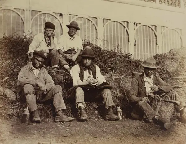Workmen sitting on a bank, in front of the Crystal Palace enjoying breakfast, 1852