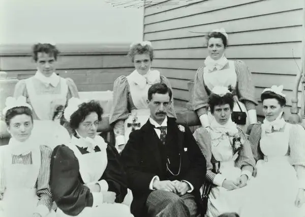 Nurses and Dr T F. Ricketts, sitting on board one of the hospital ships