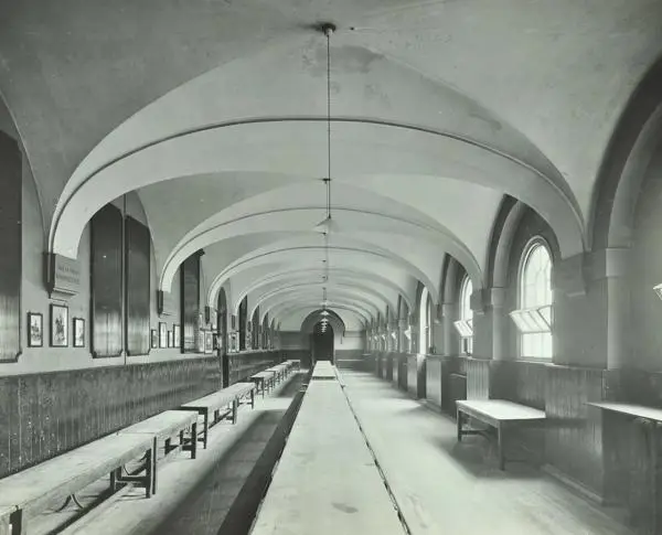 The boys dining hall, with long tables and benches, at the Foundling Hospital in 1912