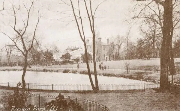 View of Ruskin Park, Camberwell with children walking around the lake, 1900
