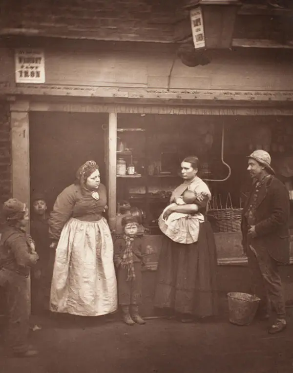 People affected by flooding in front of a shop window