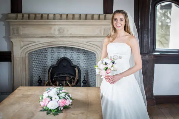 A bride poses for her wedding photography in the Hunting Lodge